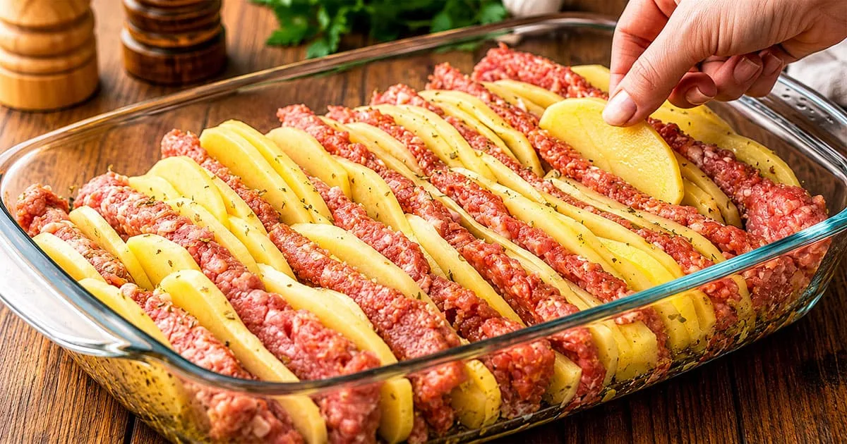 Layered potato and beef casserole with cheese